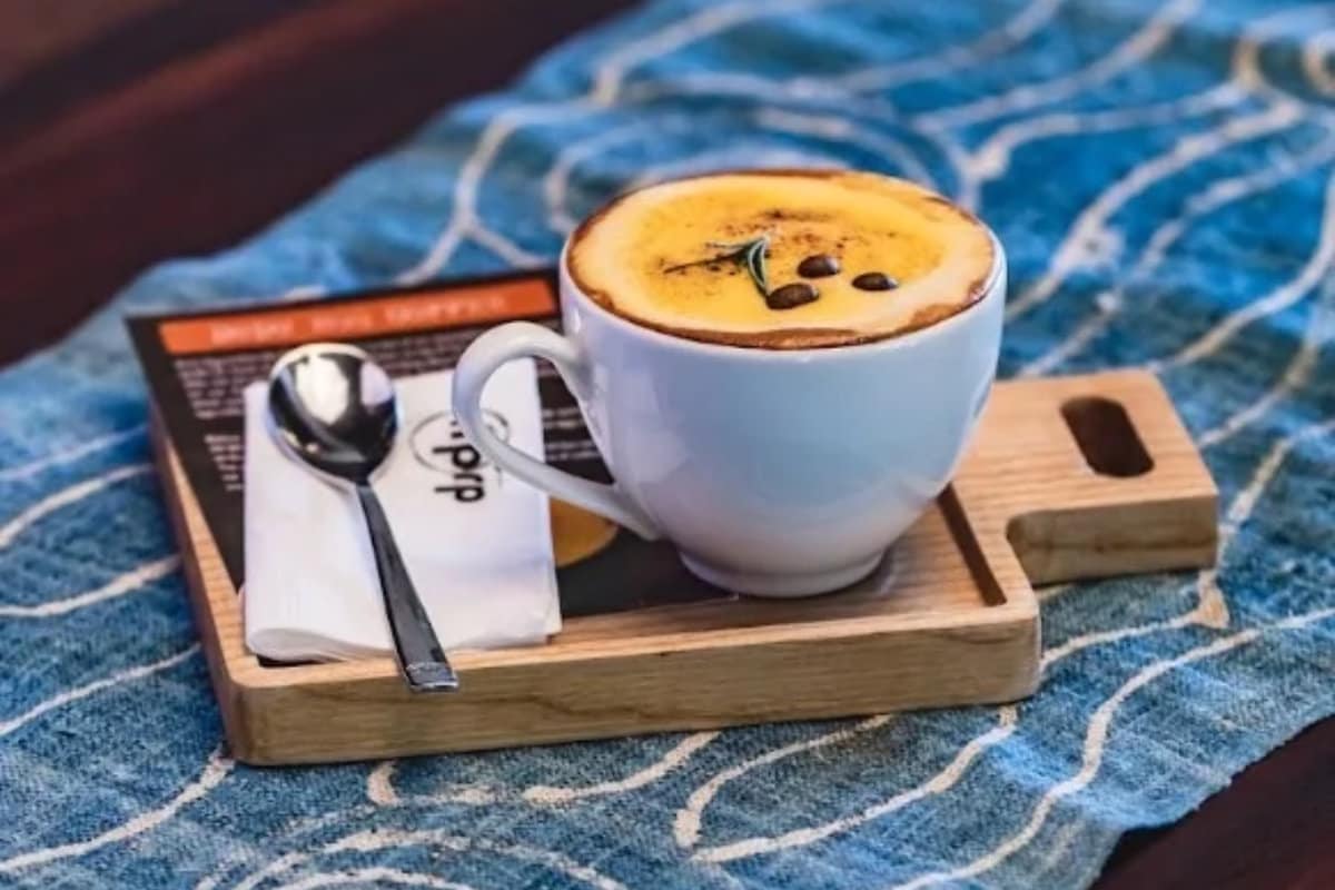 Instagram-worthy egg coffee presentation with elaborate garnishes and artistic foam art